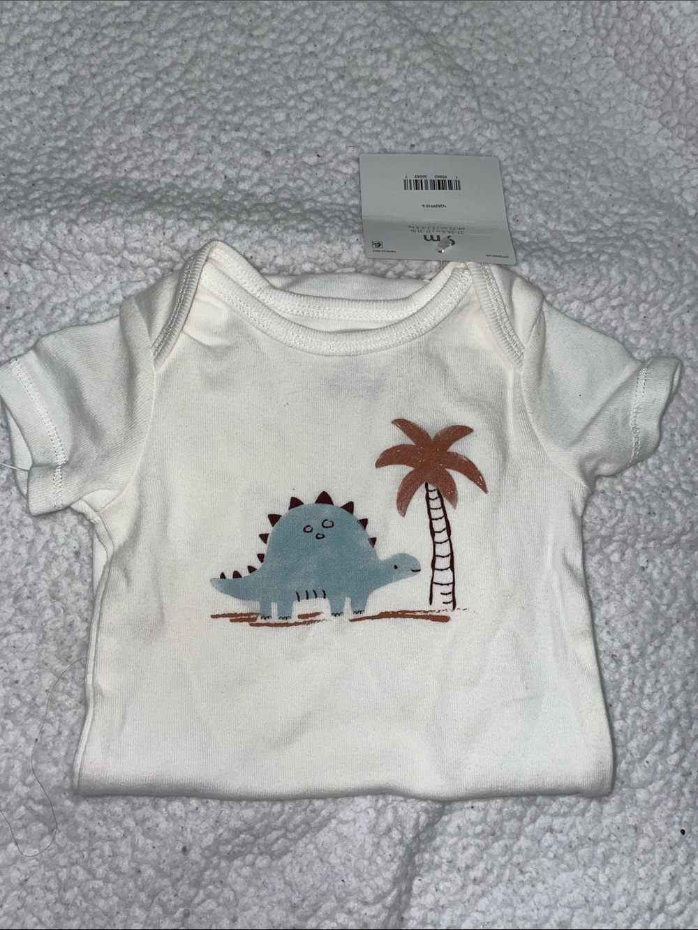 White Baby Onesie with Blue Dinosaur and Brown Palm Print